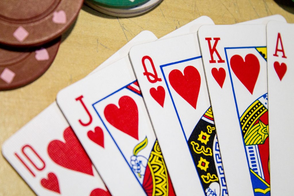 5 card poker cards on game table
